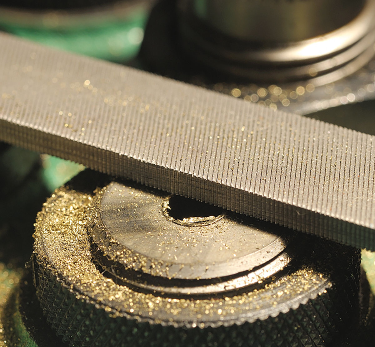 Before removing the case from the trim die, finish with a fine file, as shown.